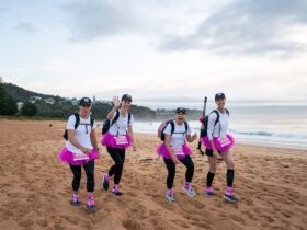 a team of women walking on the beach in tutus