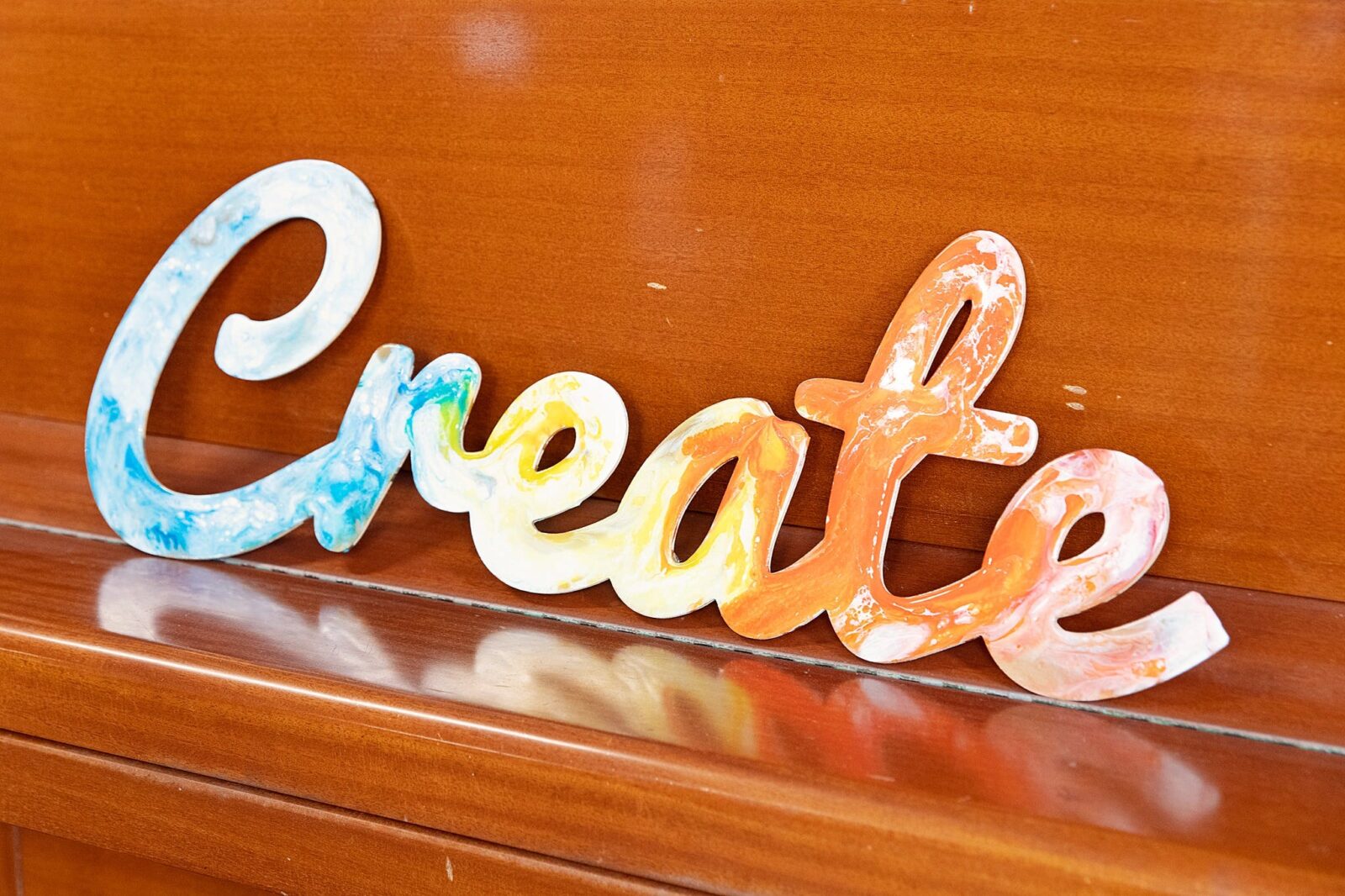 A sign that says create in marbled colour