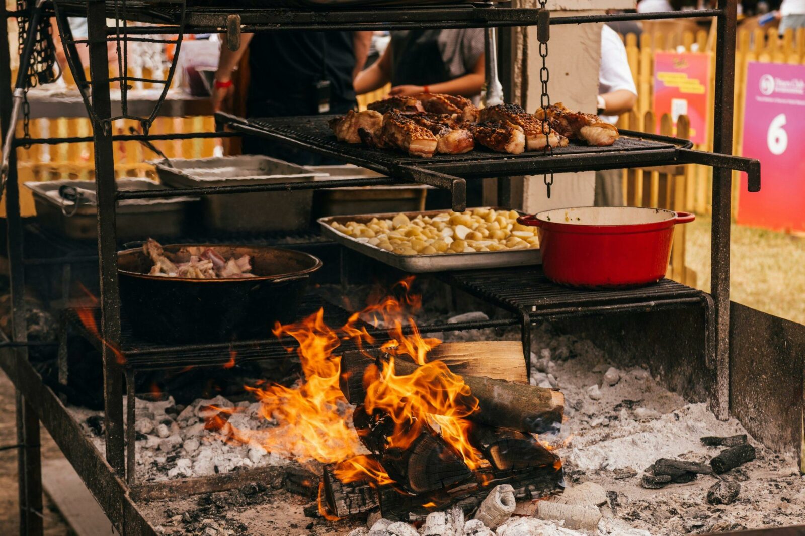 Cooking food over fire at a live open outdoor event