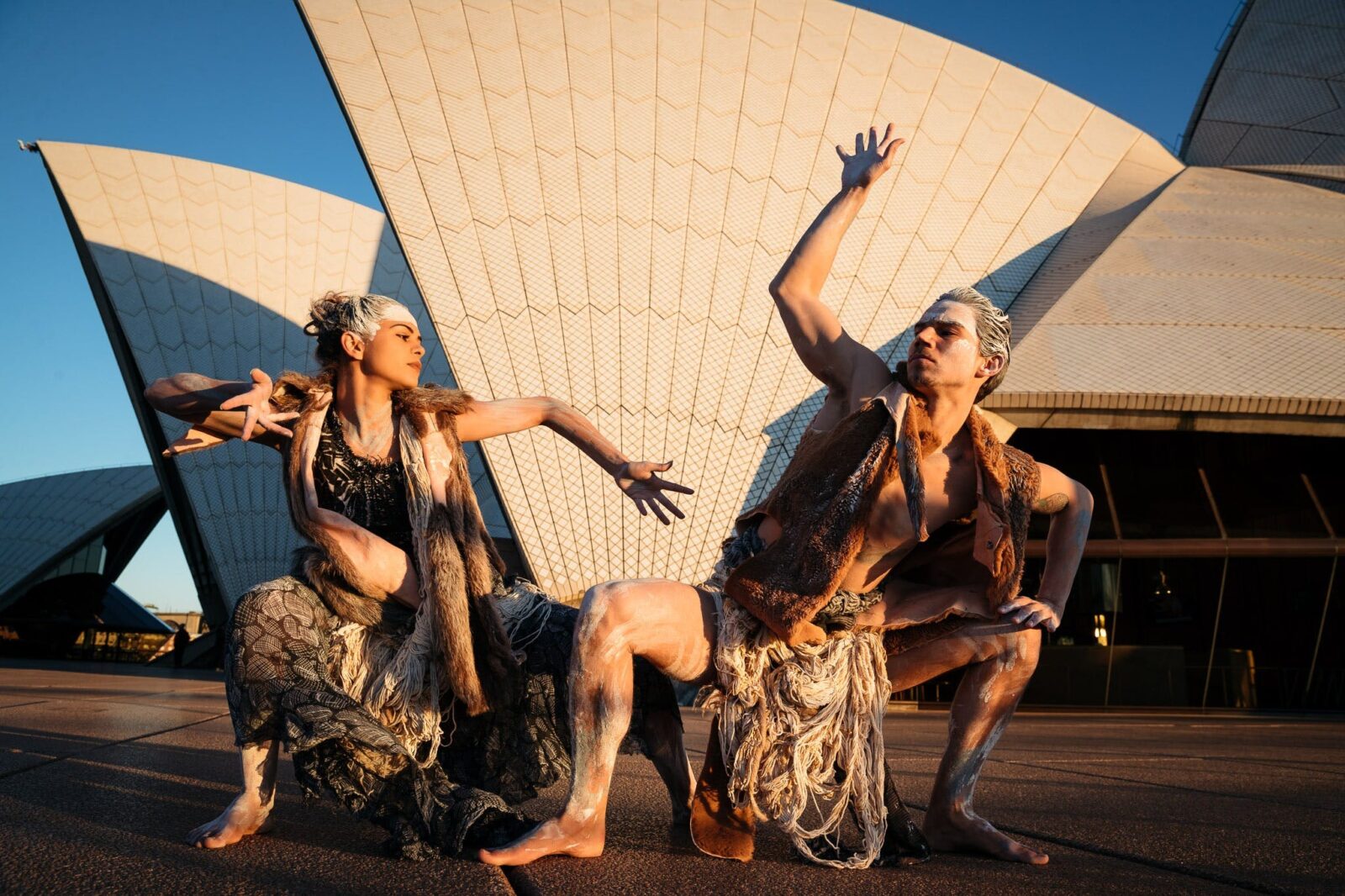 Two Indigenous Bangarra dancers outside Sydney Opera House