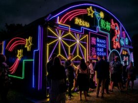 Neon lit venue with people outside