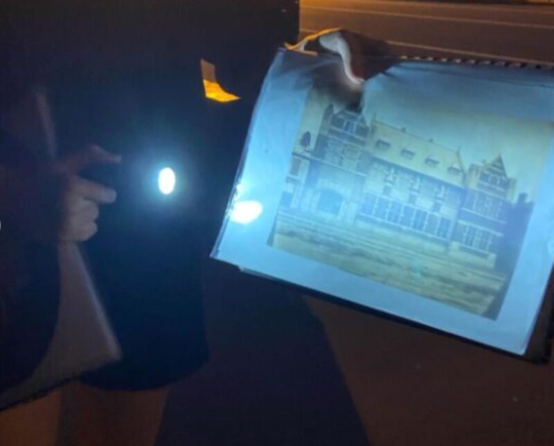 A person holding a light up picture