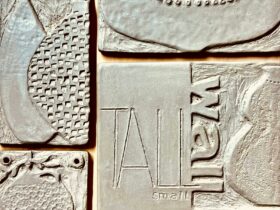 A photograph of ceramic tiles with shapes and textures carved into them