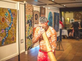 Performer plaing the yidaki as he leads guests throuhg the art display on wupa opening night.
