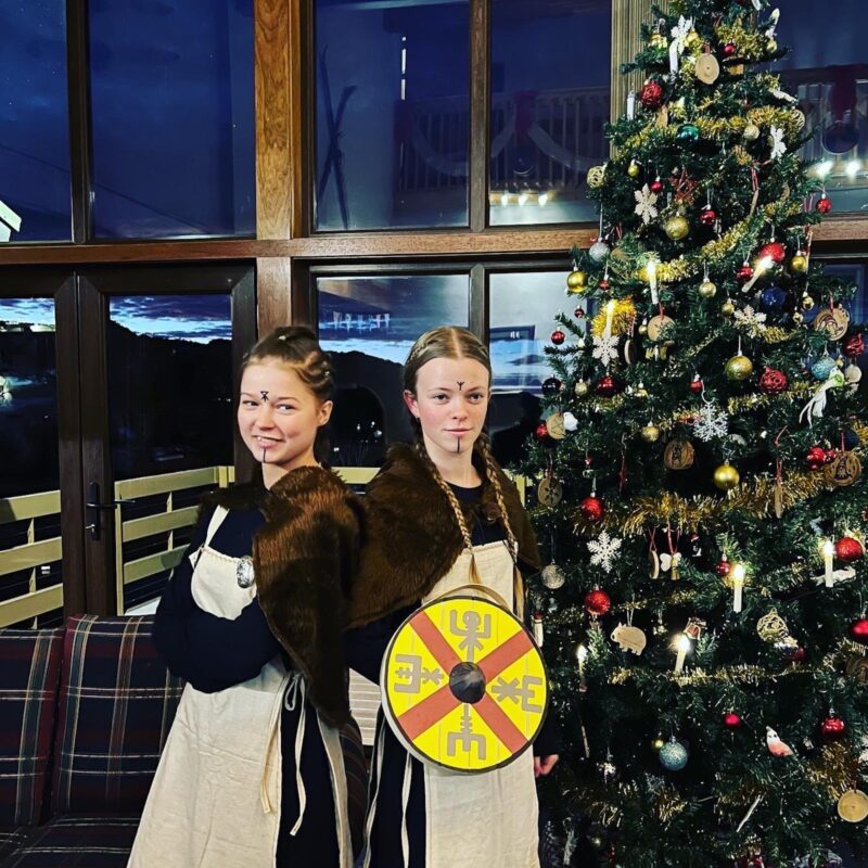Viking maidens in front of Yule Tree