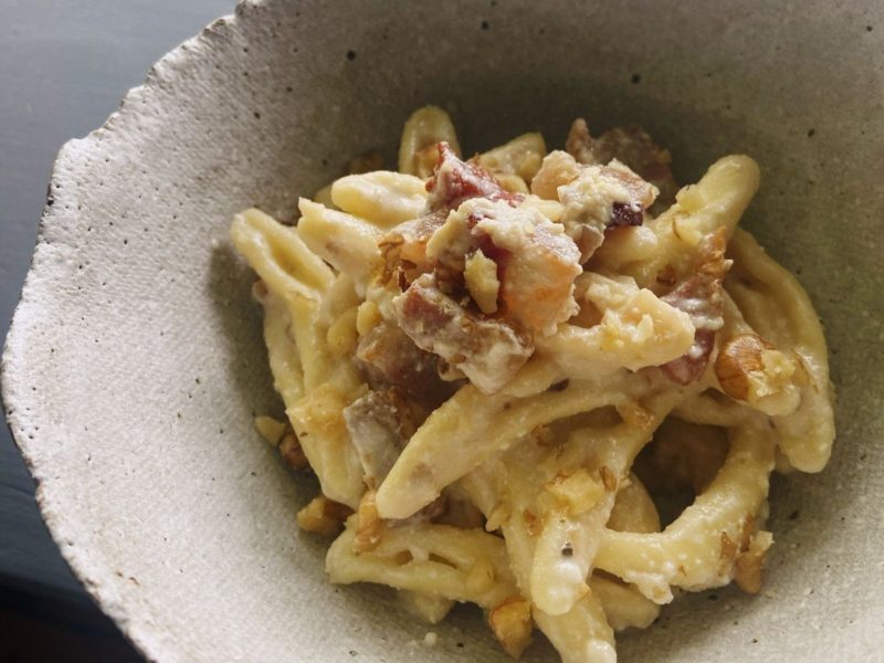Bowl of pasta with walnuts and guanciale