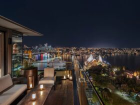 Nighttime view of Sydney Opera House and Harbour from rooftop terrace