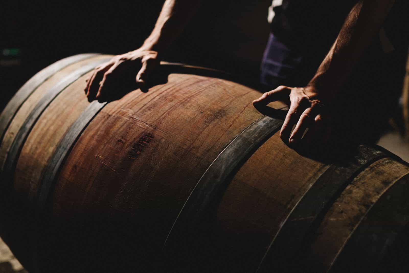 Winemaker rolling barrel