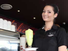 Waitress holding a milkshake