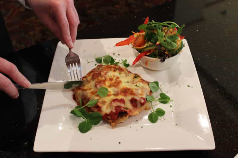 Chicken Parmigiana served with side salad or medley of vegetables