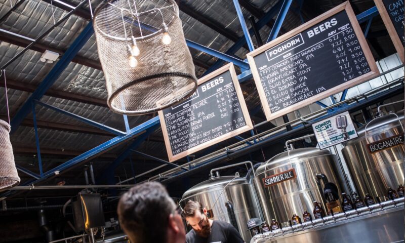 A customer viewing the beer menu chalkboards which hang above the 16 taps and four serving tanks