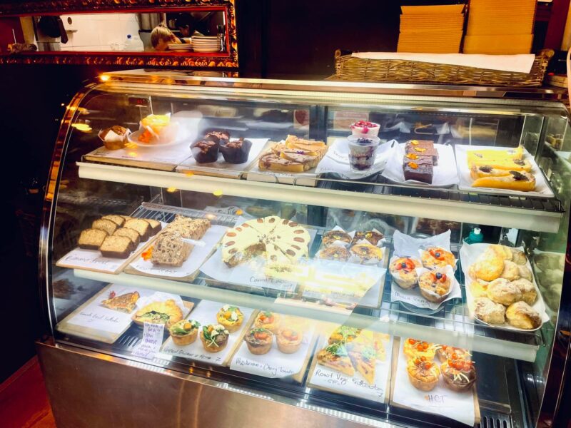JuJu's Cafe cabinet filled with savoury and sweet goodies like quiches, cakes and tarts, l