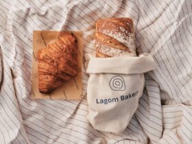 lagom bakery rustic white sourdough loaf and croissant on a linen spread