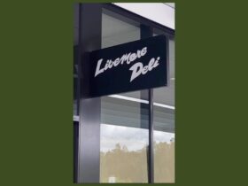 A sign on the outside of a shop saying 'Livemore Deli'