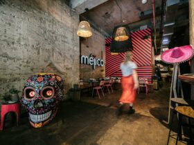 Blurred woman walking in front of large skull, into a restaurant