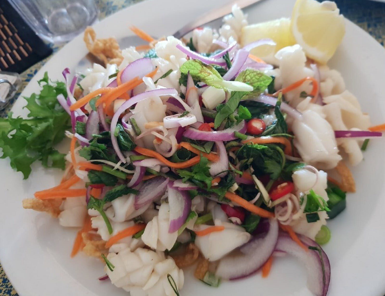 Thai dish with red onions, squid, lemon and mint.
