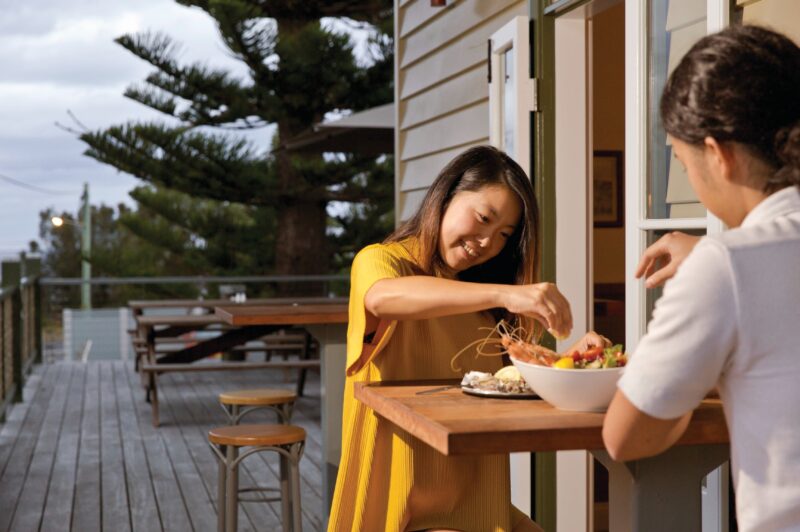Couple enjoying fresh seafood available on the menu at Tathra Hotel, Tathra