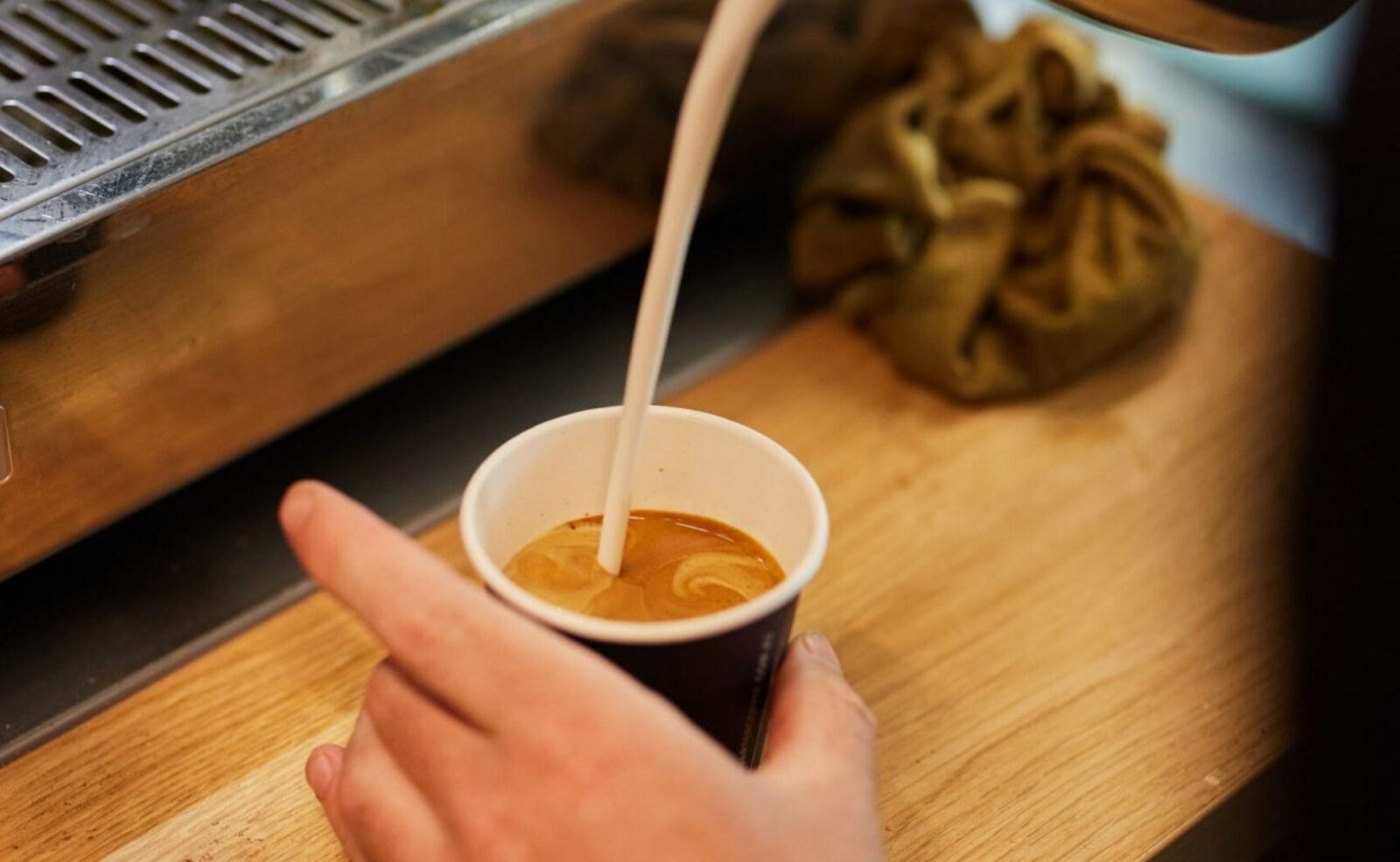 milk being poured in coffee