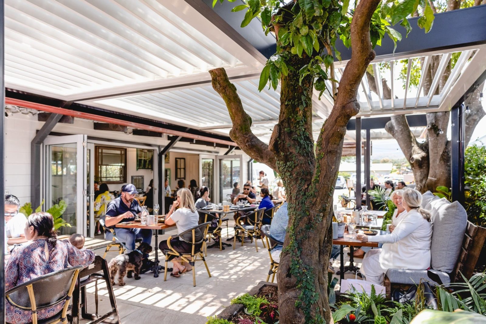All-Weather covered outdoor dining, with vergola awning and shutters that let in the light