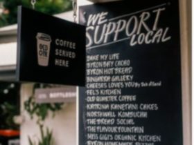 Board listing all local produce and items