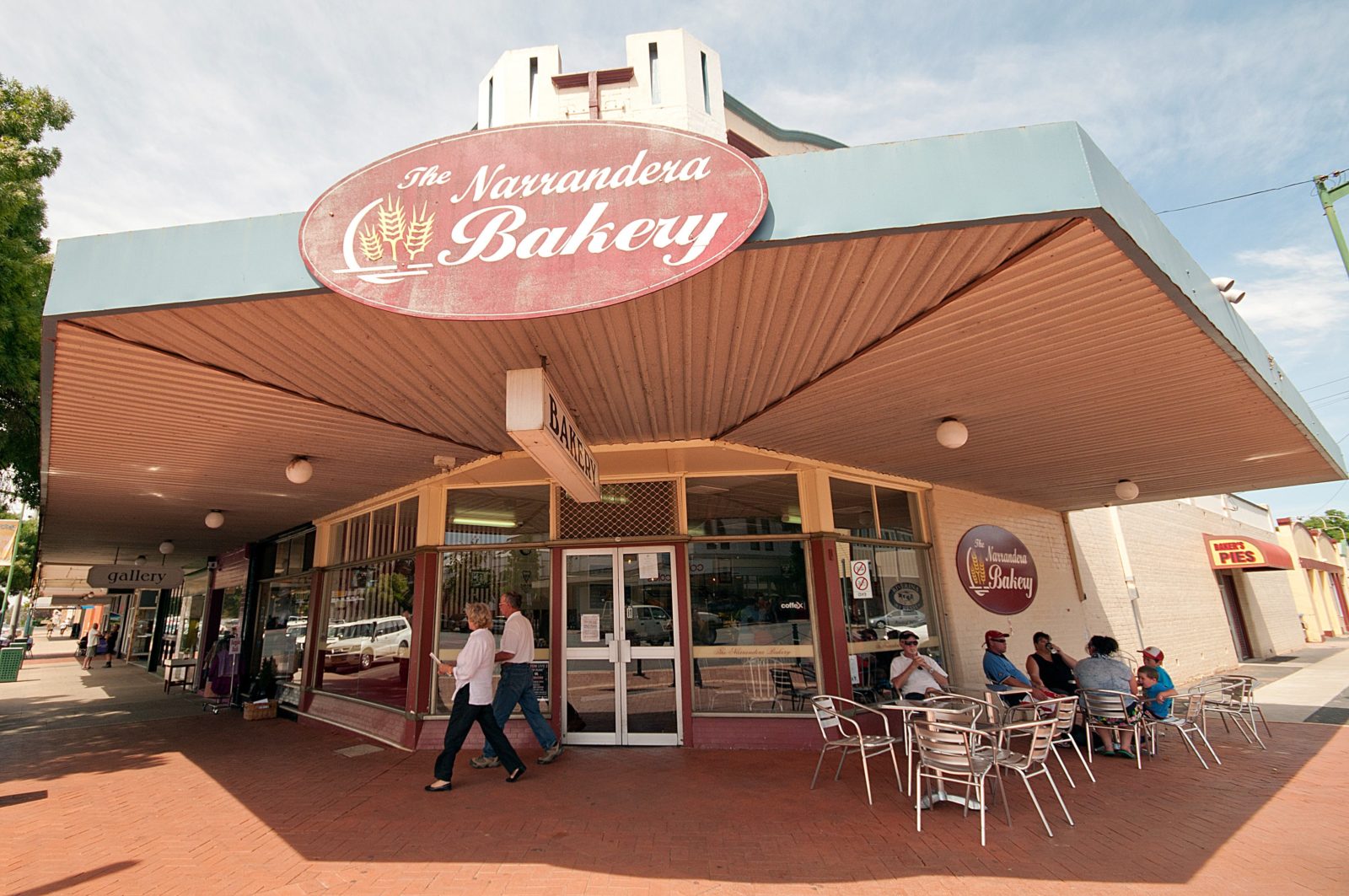 Outside view of Narrandera Bakery with customers enjoying a meal