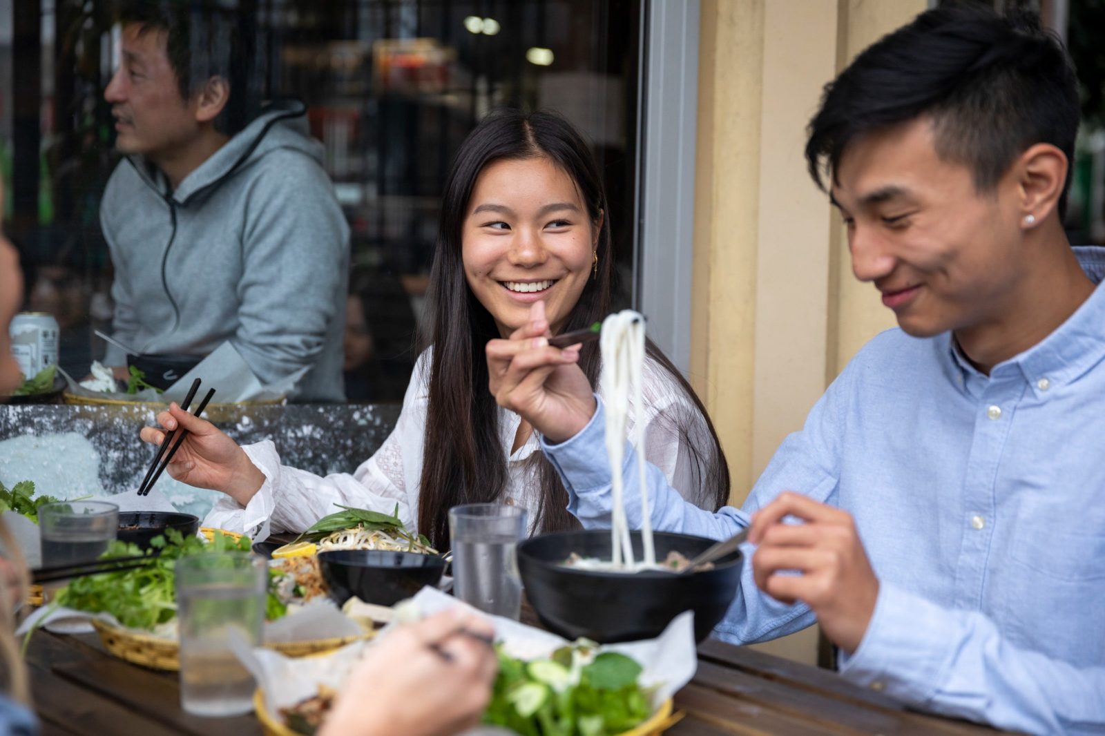 Couple enjoying food and drink at VN Street Foods, Marrickville