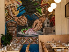 The image displays a vibrant and artistic dining area in the Warike restaurant, featuring a mural of