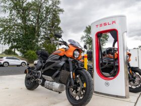 An electric Motorcycle charging at a Tesla Electric Vehicle Charger