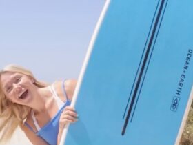 Surfboard Hire. Girl holding a surfboard that was for hire