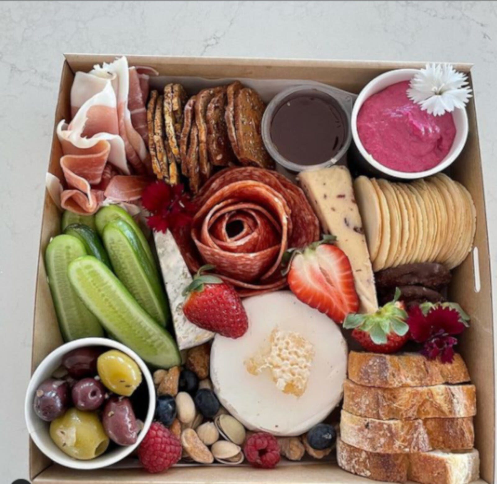 A colourful platter of fruit, cheeses and crackers