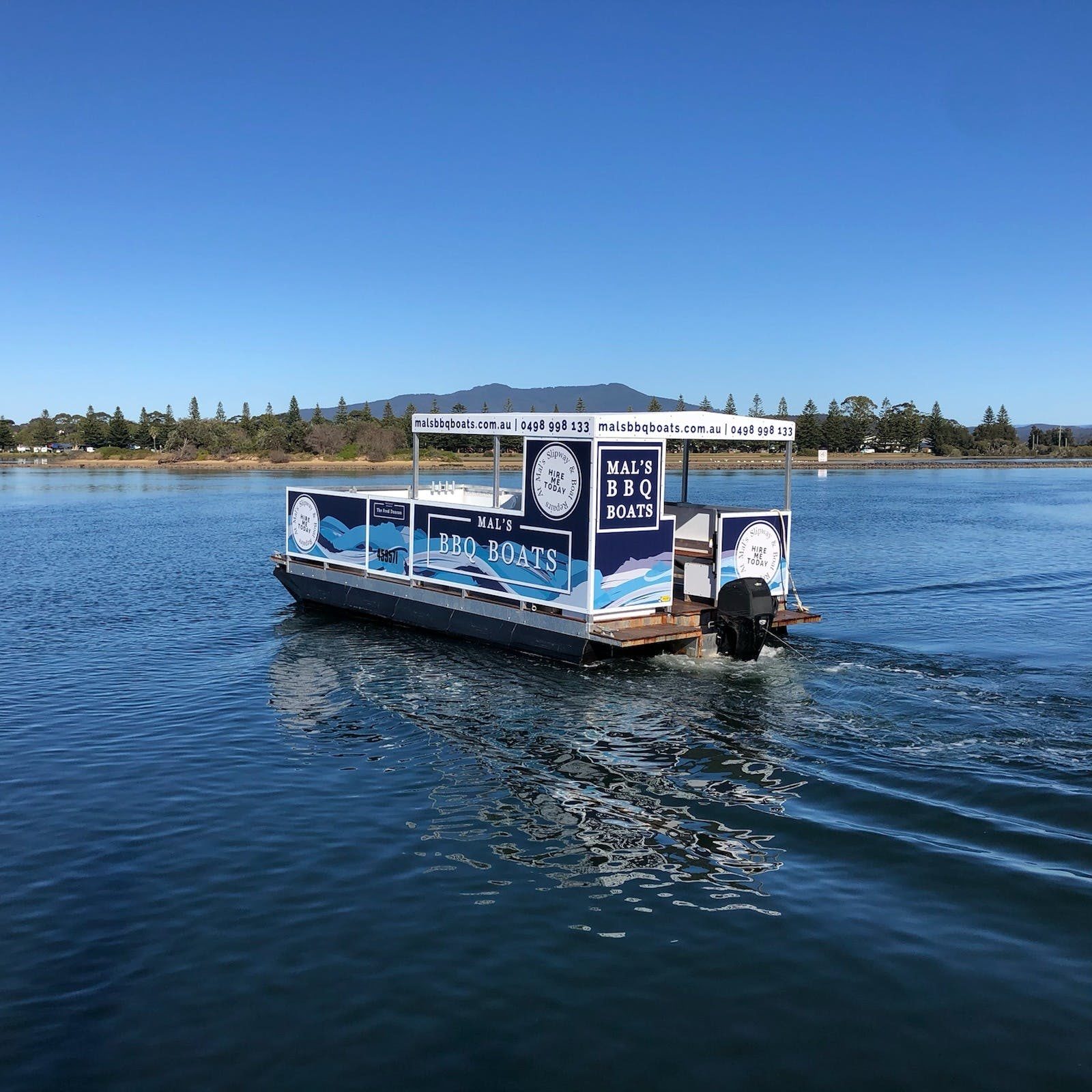 Mal's BBQ Boat drives along Wagonga Inlet in narooma