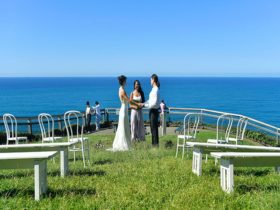 A couple saying their vows with the ocean in the background at Most Easterly Point in Cape Byron