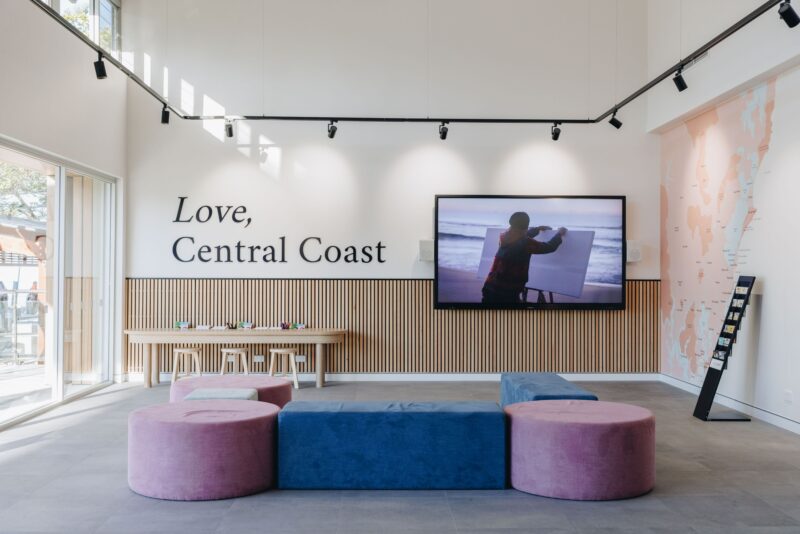Inside the Central Coast Visitor Centre, Love Central Coast signage, Audio screen with local footage