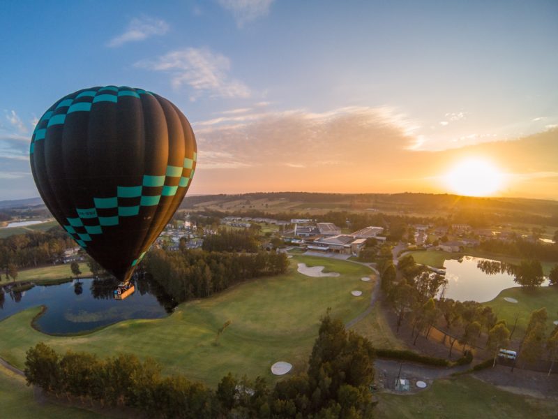 Hot air balloon over golf course