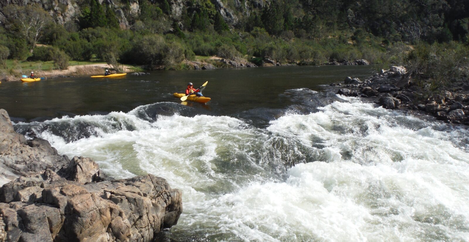 A nervous kayaker lines up on a rapid during the Walking Rivers Snow River, two other Kayaks waiting