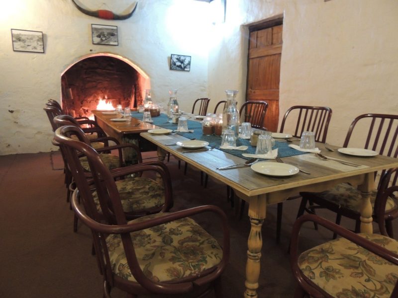 The dining room set for dinner with the fire blazing