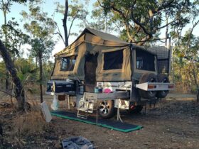 Camper trailer set up at campsite at Samson Creek Nature Park.