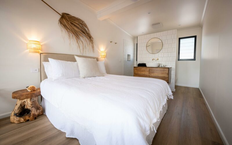 Ocean Room capturing bed, vanity, shower and toilet areas