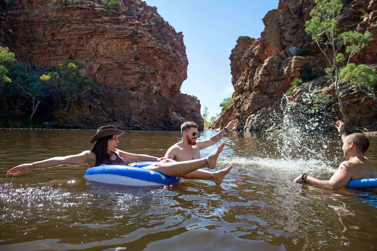 A group of friends swimming and splashing in Ellery Creek Big Hole