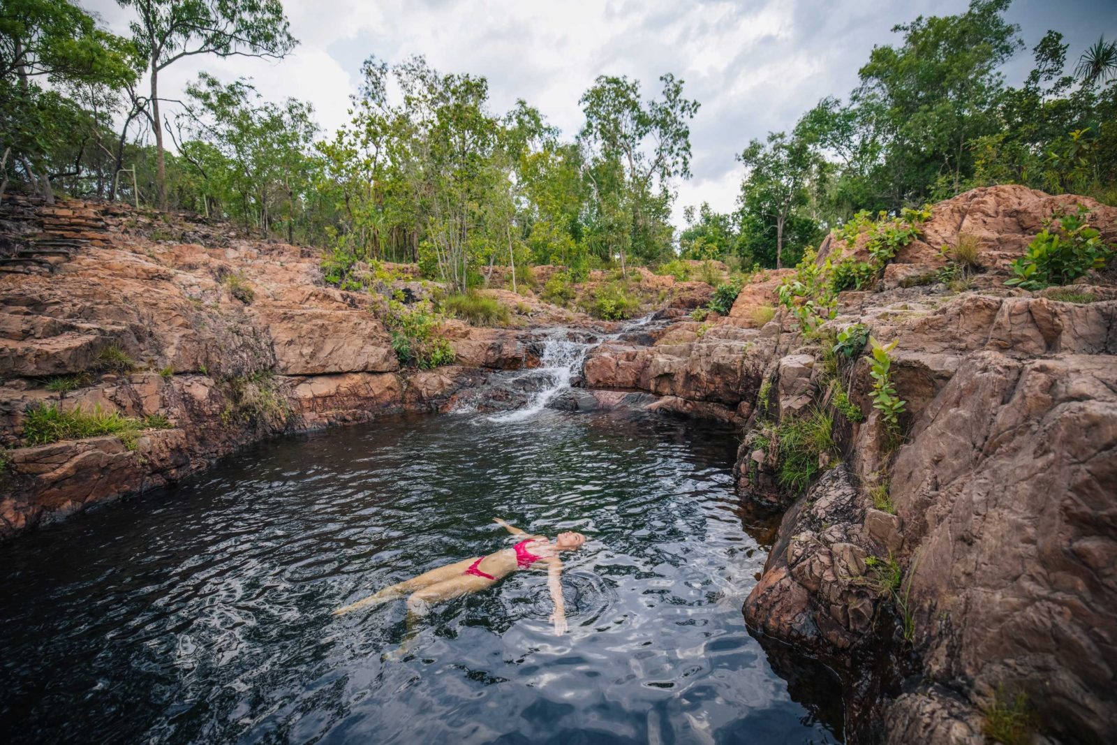 Woman floating in water at Bulley Rockhole in Litchfield National Park