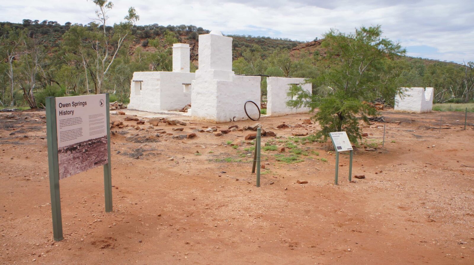 Old Owen Springs Homestead site, showing some interpretive signage and wire fencing around buildings