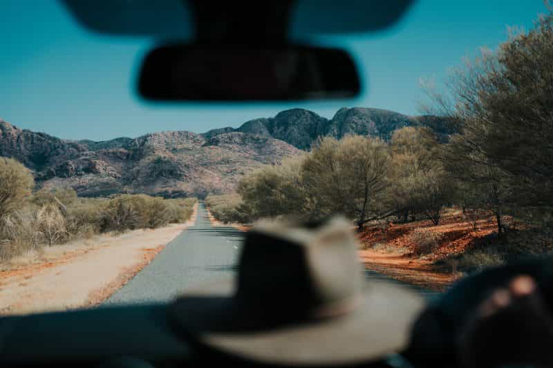Hat on the dashboard of a car driving through the Red Centre