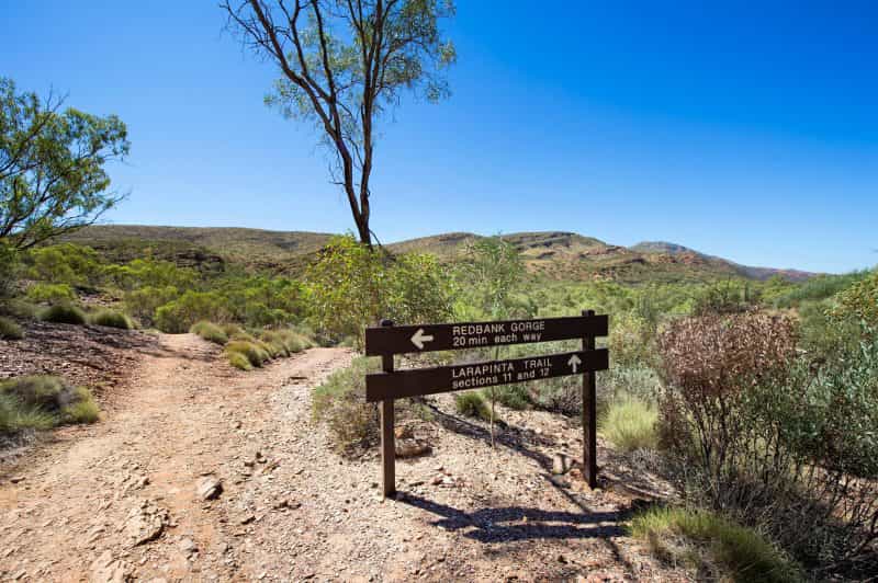 Signs along the Larapinta Trail showing directions to Redbank Gorge
