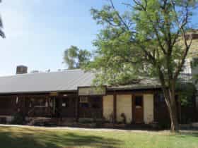 General view of Ross River Homestead, the old homestead building (white walled) visible to the right-hand side of the photo incorporated into a larger tourist complex.