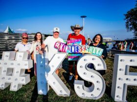 Kindness Shake co founder and stakeholders posing behind Kindess Festival letters