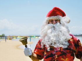 Santa with his bell in a Hawaiian shirt