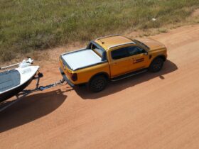 NT 4x4 Hire Yellow towing a boat on NT roads