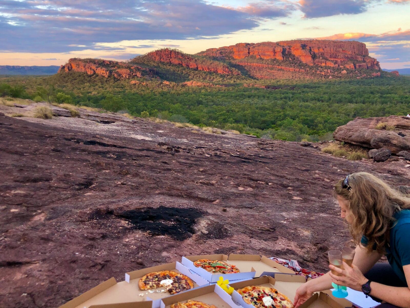 people eating pizza at special site in kakadu