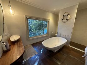 Bathroom with large avocado bathtub, shower and toilet