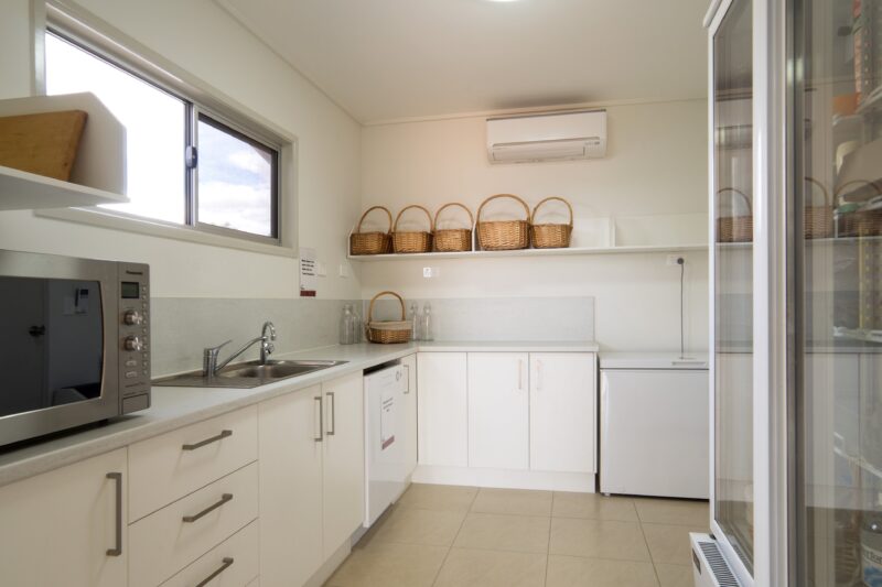 Guest kitchenette includes a glass fronted orford fridge and basic food prep utensils.